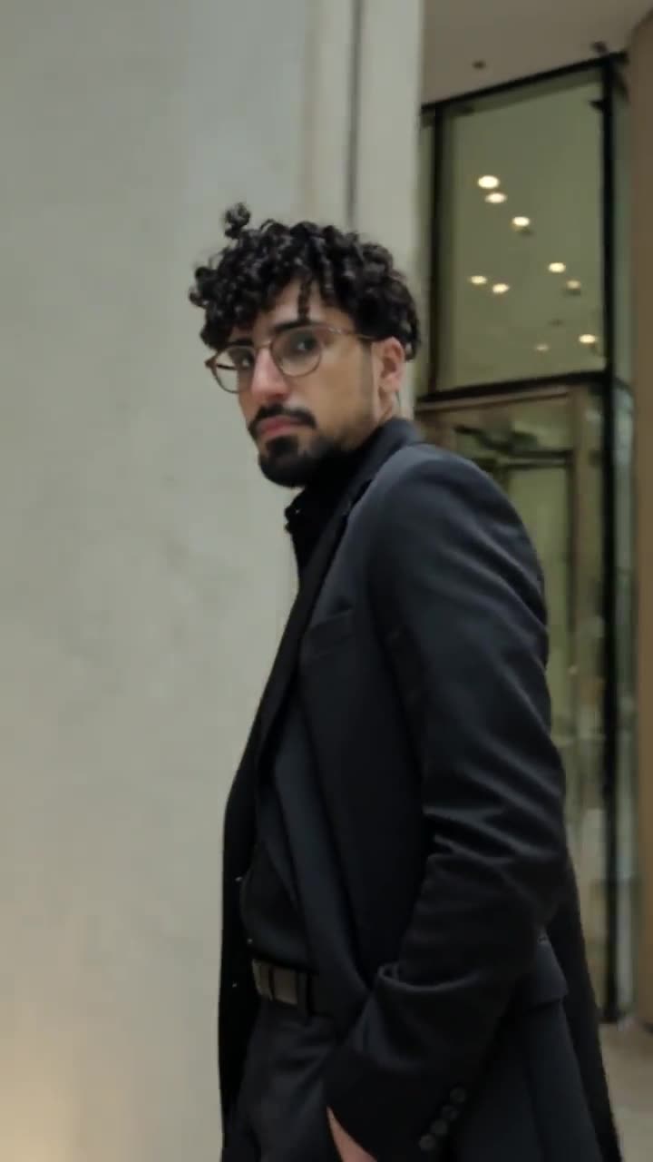 Montage of Omar in a black suit moving through the city